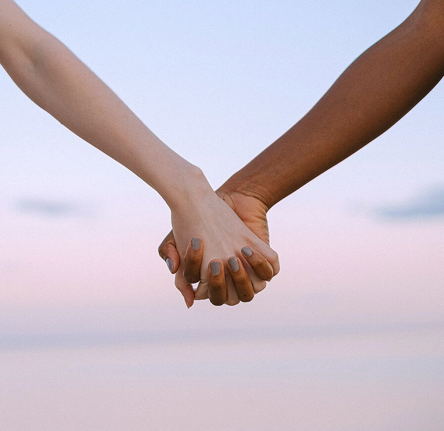 Two people holding hands